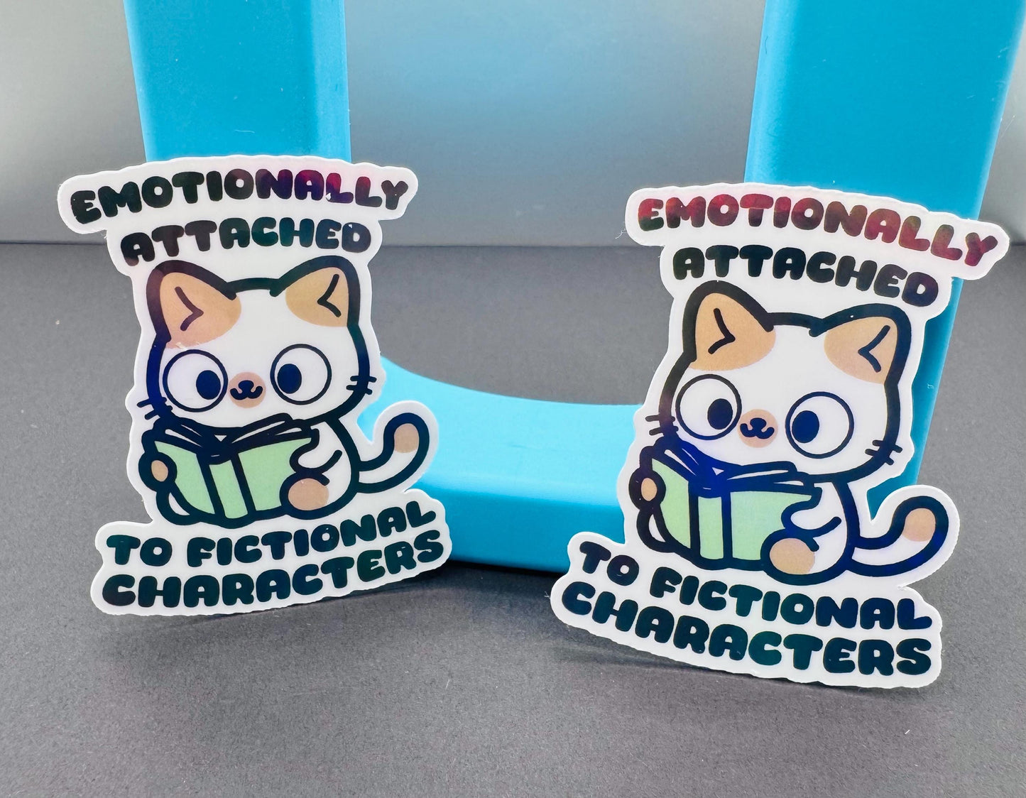 Holographic Cat Reading Sticker: Emotionally Attached to Fictional Characters